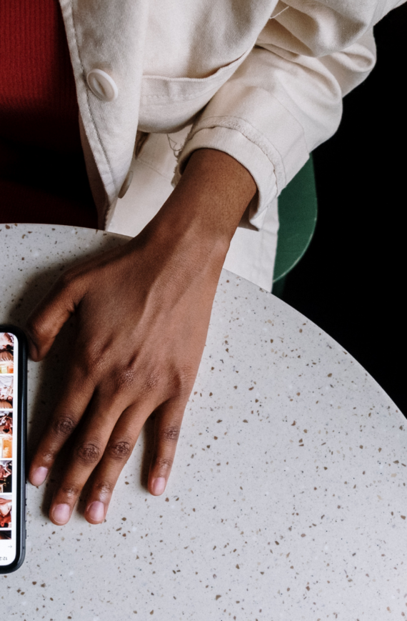 franklin music academy black woman searching online via smartphone - finding the perfect music school for kids