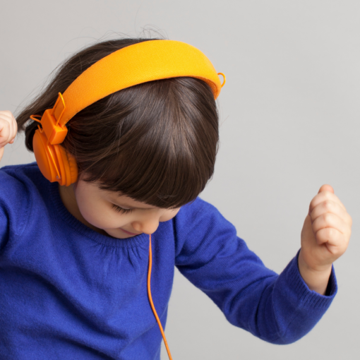 franklin music academy young girl listening to music with yellow headphones - private music lessons in Austin