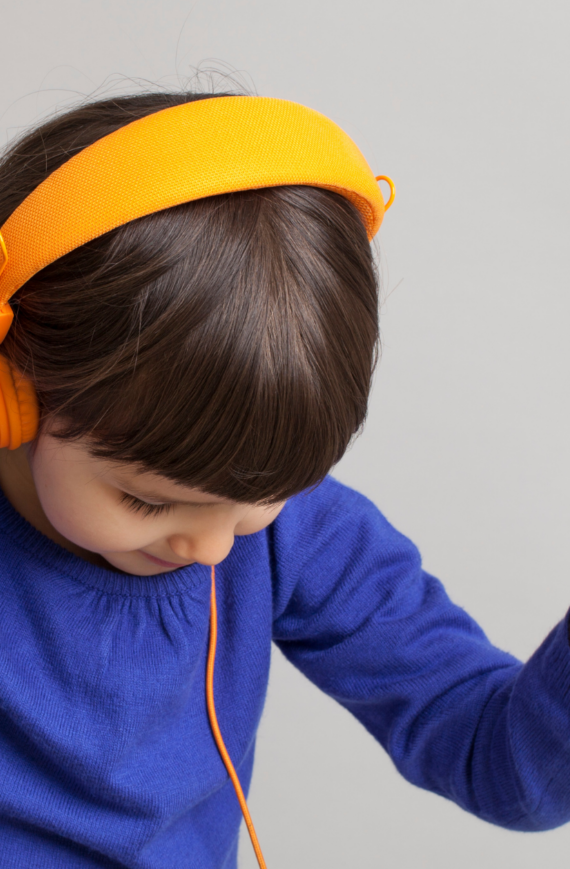 franklin music academy young girl listening to music with yellow headphones - private music lessons in Austin
